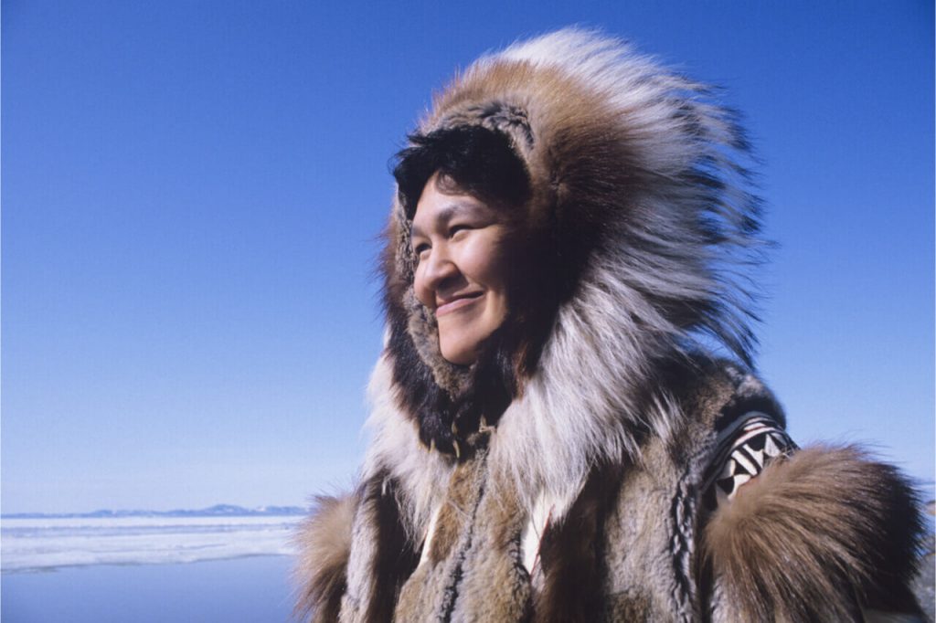 The Inuit wearing animal skin as their coat.